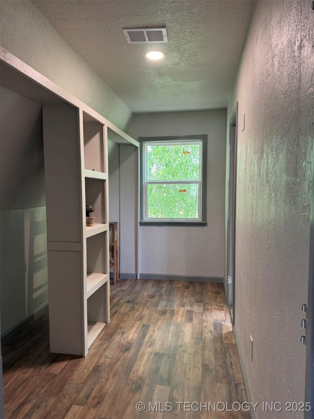 7235 Sunshine Rd, Davis, OK 73030 - walk in closet with dark wood-type flooring