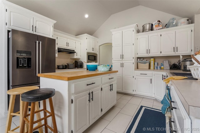 1105 N Joshua Ave, Broken Arrow, OK 74012 - kitchen with appliances with stainless steel finishes, vaulted ceiling, white cabinetry, under cabinet range hood, and recessed lighting