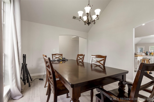 1105 N Joshua Ave, Broken Arrow, OK 74012 - dining area with vaulted ceiling, arched walkways, baseboards, and a chandelier