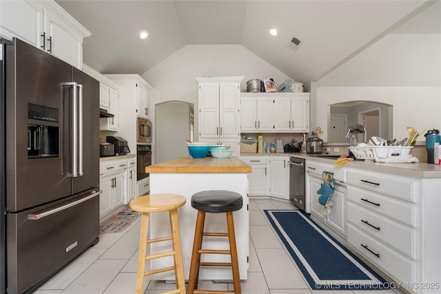 1105 N Joshua Ave, Broken Arrow, OK 74012 - kitchen with appliances with stainless steel finishes, arched walkways, lofted ceiling, a center island, and a breakfast bar area