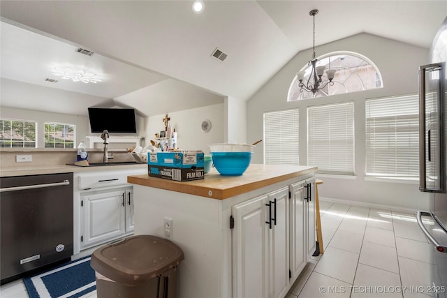 1105 N Joshua Ave, Broken Arrow, OK 74012 - kitchen featuring dishwasher, vaulted ceiling, a sink, white cabinets, and butcher block counters