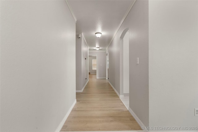 1105 N Joshua Ave, Broken Arrow, OK 74012 - hallway featuring arched walkways, crown molding, light wood-style floors, and baseboards