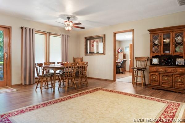 1485 Old Ketchum Rd, Langley, OK 74350 - dining area with wood finished floors, a ceiling fan, and baseboards