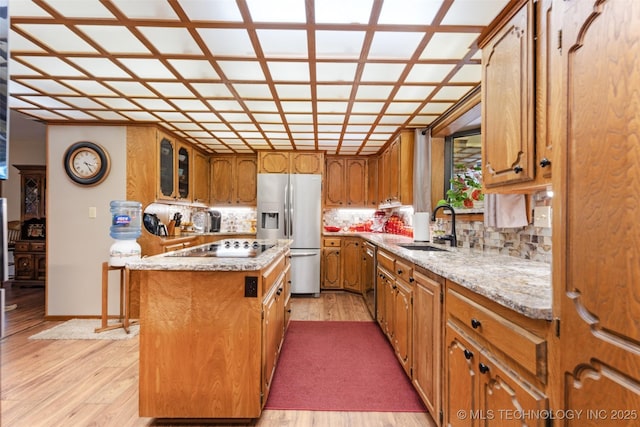 1485 Old Ketchum Rd, Langley, OK 74350 - kitchen featuring stainless steel appliances, a sink, a center island, tasteful backsplash, and brown cabinets