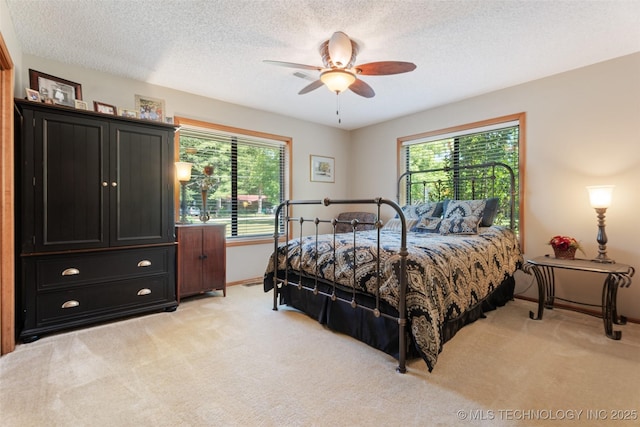 1485 Old Ketchum Rd, Langley, OK 74350 - bedroom featuring light colored carpet, a textured ceiling, baseboards, and a ceiling fan