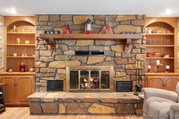 1485 Old Ketchum Rd, Langley, OK 74350 - living area with a stone fireplace and wood finished floors