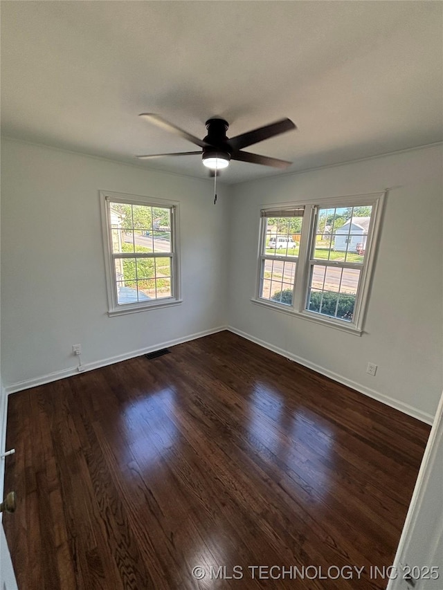 4607 E 4th Pl, Tulsa, OK 74112 - unfurnished room with plenty of natural light, ceiling fan, dark wood-style floors, and baseboards