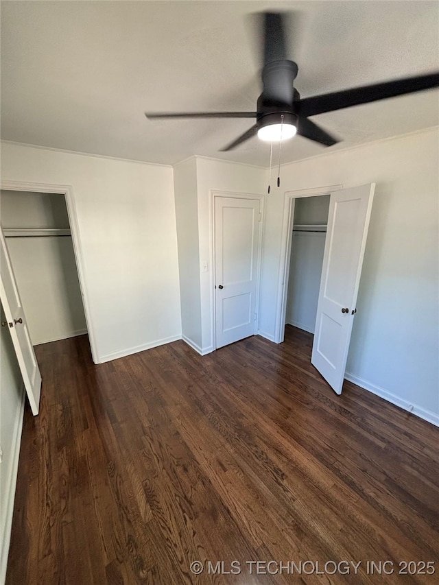 4607 E 4th Pl, Tulsa, OK 74112 - unfurnished bedroom featuring dark wood-style flooring, baseboards, and a ceiling fan