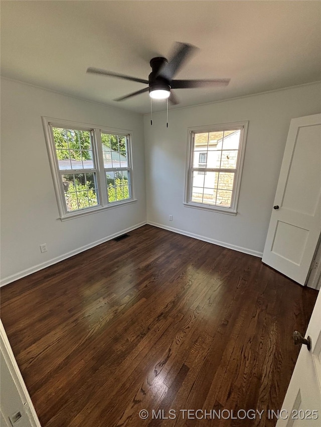 4607 E 4th Pl, Tulsa, OK 74112 - unfurnished room with dark wood-style flooring, ceiling fan, and baseboards