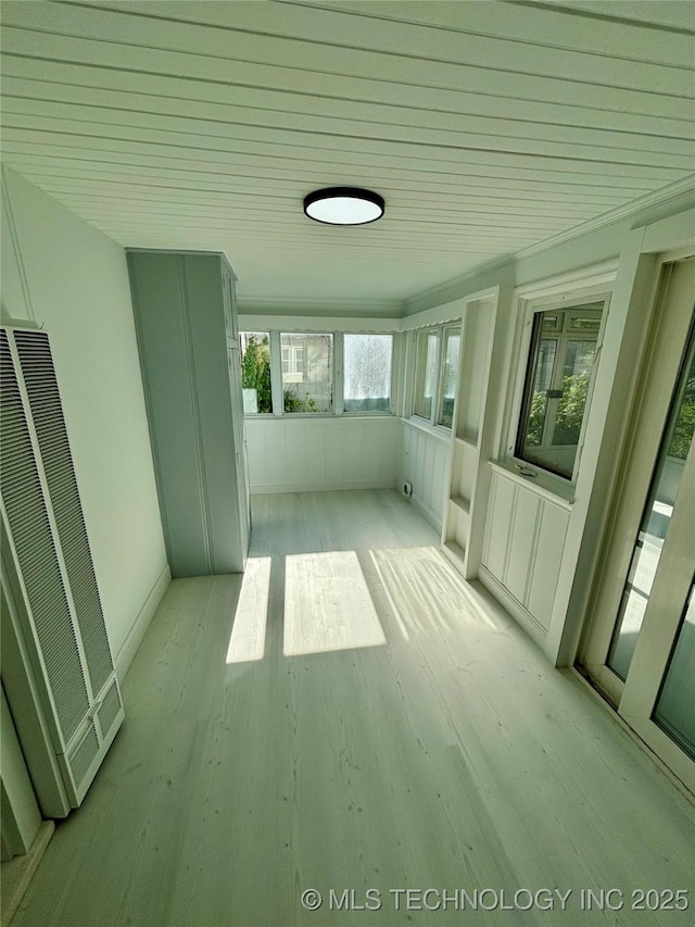 4607 E 4th Pl, Tulsa, OK 74112 - unfurnished sunroom featuring a heating unit and wood finished floors