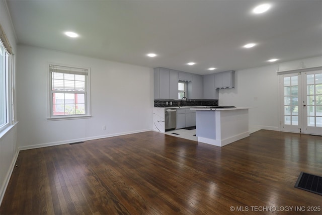 4607 E 4th Pl, Tulsa, OK 74112 - kitchen featuring dishwasher, open floor plan, healthy amount of natural light, dark wood-style flooring, and recessed lighting