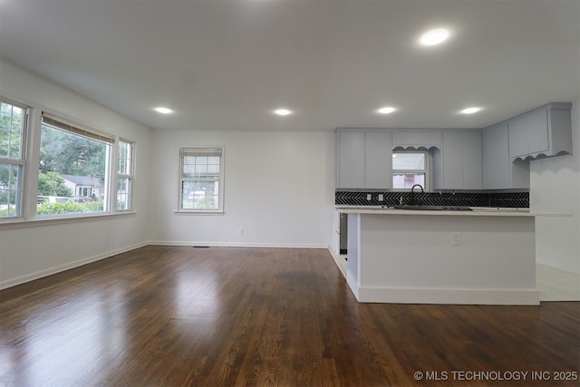 4607 E 4th Pl, Tulsa, OK 74112 - kitchen featuring plenty of natural light, dark wood-type flooring, recessed lighting, and gray cabinetry