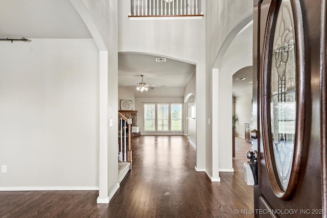 1620 E Granger St, Broken Arrow, OK 74012 - entryway featuring arched walkways, ceiling fan, baseboards, dark wood-type flooring, and a brick fireplace