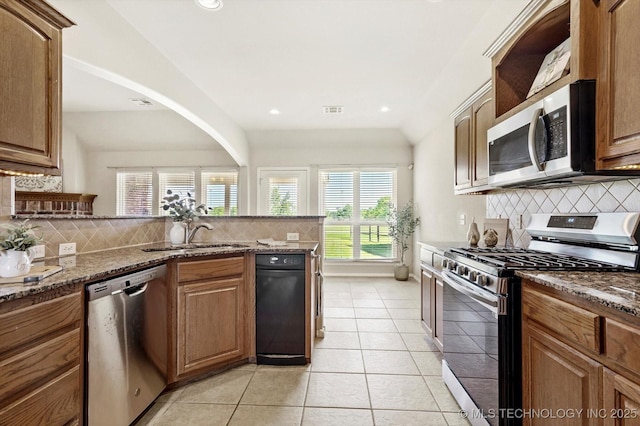 1620 E Granger St, Broken Arrow, OK 74012 - kitchen with appliances with stainless steel finishes, backsplash, a sink, dark stone counters, and light tile patterned floors