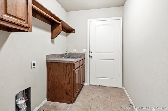 1620 E Granger St, Broken Arrow, OK 74012 - laundry area featuring baseboards, hookup for an electric dryer, light tile patterned floors, and cabinet space