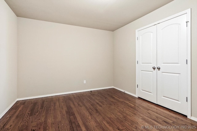 1620 E Granger St, Broken Arrow, OK 74012 - unfurnished bedroom with dark wood-style flooring, baseboards, and a closet