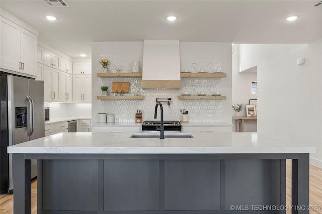 10215 E 121st Pl S, Bixby, OK 74008 - kitchen featuring stainless steel refrigerator with ice dispenser, open shelves, decorative backsplash, light wood-style flooring, and recessed lighting