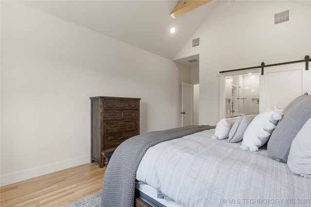 10215 E 121st Pl S, Bixby, OK 74008 - bedroom featuring high vaulted ceiling, light wood-style flooring, baseboards, a barn door, and recessed lighting