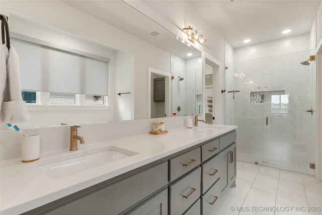 10215 E 121st Pl S, Bixby, OK 74008 - full bath with double vanity, a shower stall, tile patterned flooring, and recessed lighting