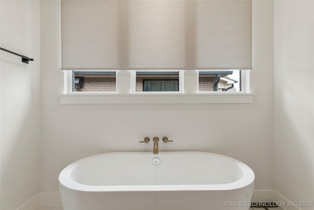 10215 E 121st Pl S, Bixby, OK 74008 - bathroom with a soaking tub and baseboards