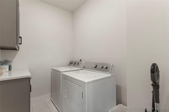 10215 E 121st Pl S, Bixby, OK 74008 - laundry room featuring cabinet space, washer and dryer, light tile patterned floors, and baseboards