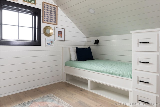 67 Lower Green Way Unit B, Carlton Landing, OK 74432 - bedroom with vaulted ceiling, wood finished floors, and wooden walls