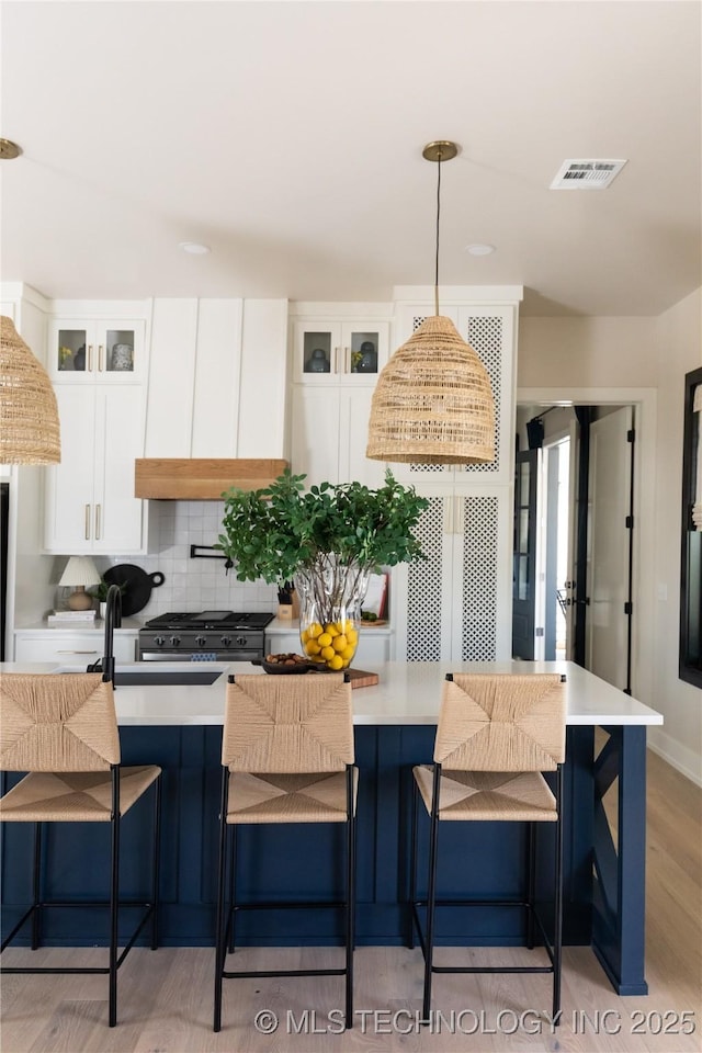 67 Lower Green Way Unit B, Carlton Landing, OK 74432 - kitchen featuring gas stove, light wood-style floors, white cabinets, and light countertops