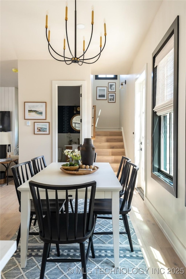 67 Lower Green Way Unit B, Carlton Landing, OK 74432 - dining room featuring stairs, a chandelier, light wood finished floors, and baseboards