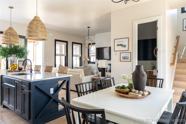 67 Lower Green Way Unit B, Carlton Landing, OK 74432 - dining space featuring a chandelier, light wood-type flooring, and stairs