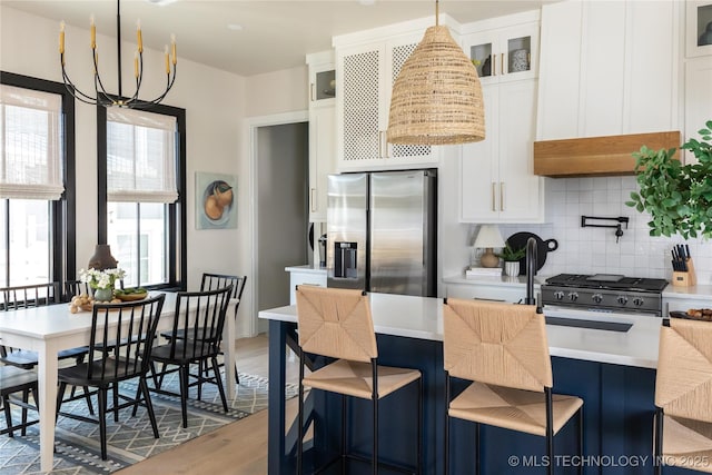 67 Lower Green Way Unit B, Carlton Landing, OK 74432 - kitchen featuring stainless steel refrigerator with ice dispenser, backsplash, white cabinets, glass insert cabinets, and light wood finished floors