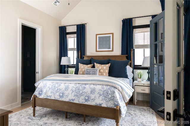 67 Lower Green Way Unit B, Carlton Landing, OK 74432 - bedroom featuring lofted ceiling, wood finished floors, and baseboards