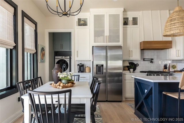 67 Lower Green Way Unit B, Carlton Landing, OK 74432 - kitchen with stainless steel fridge with ice dispenser, washer / dryer, a chandelier, light countertops, and backsplash