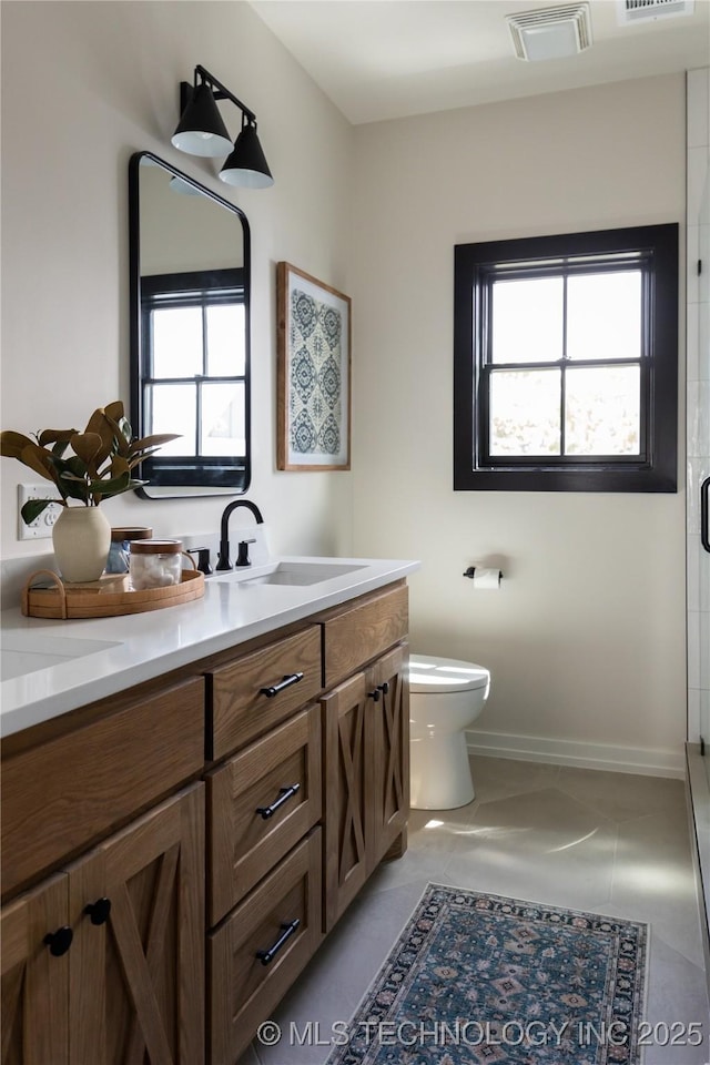 67 Lower Green Way Unit B, Carlton Landing, OK 74432 - bathroom featuring vanity, toilet, an enclosed shower, tile patterned flooring, and baseboards