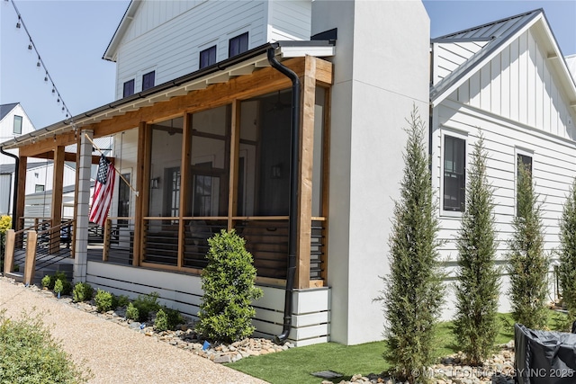 67 Lower Green Way Unit B, Carlton Landing, OK 74432 - view of property exterior with board and batten siding, metal roof, a sunroom, and a standing seam roof