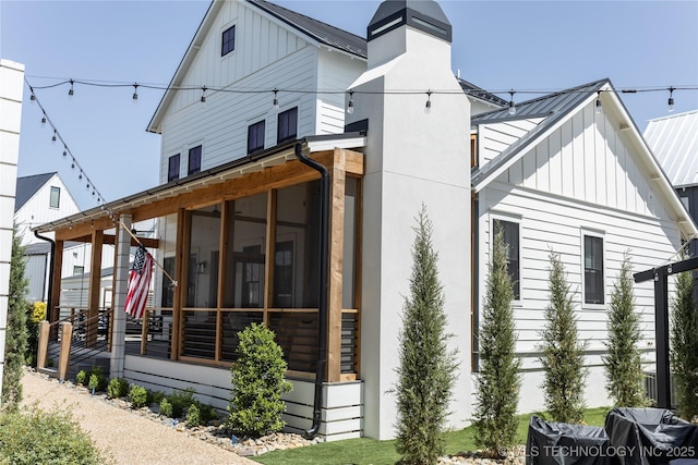 67 Lower Green Way Unit B, Carlton Landing, OK 74432 - rear view of property with board and batten siding, metal roof, and a sunroom