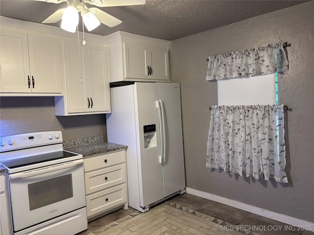 914 3rd Ave NE, Ardmore, OK 73401 - kitchen featuring white appliances, a ceiling fan, white cabinetry, a textured ceiling, and dark stone counters