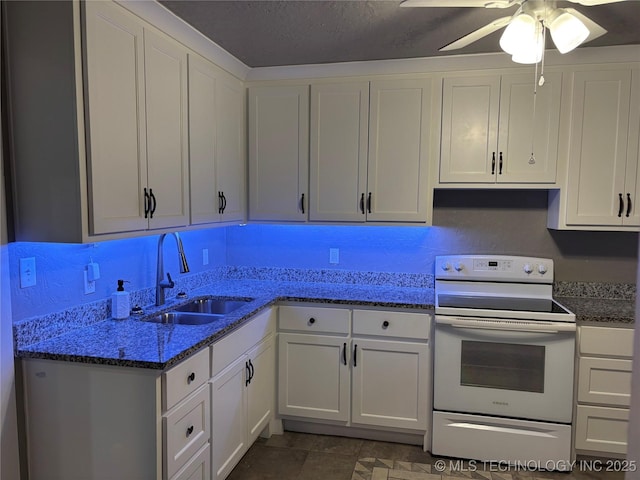 914 3rd Ave NE, Ardmore, OK 73401 - kitchen with white electric range, a sink, white cabinets, and dark stone counters