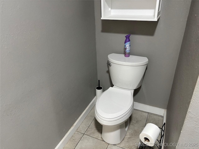914 3rd Ave NE, Ardmore, OK 73401 - bathroom with tile patterned flooring, toilet, and baseboards