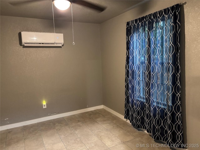 914 3rd Ave NE, Ardmore, OK 73401 - unfurnished room featuring a ceiling fan, a wall unit AC, tile patterned floors, and baseboards