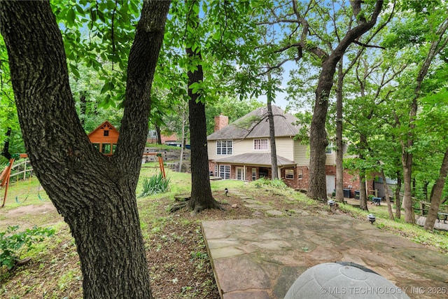 11937 S 18th St, Jenks, OK 74037 - rear view of house with brick siding and a patio