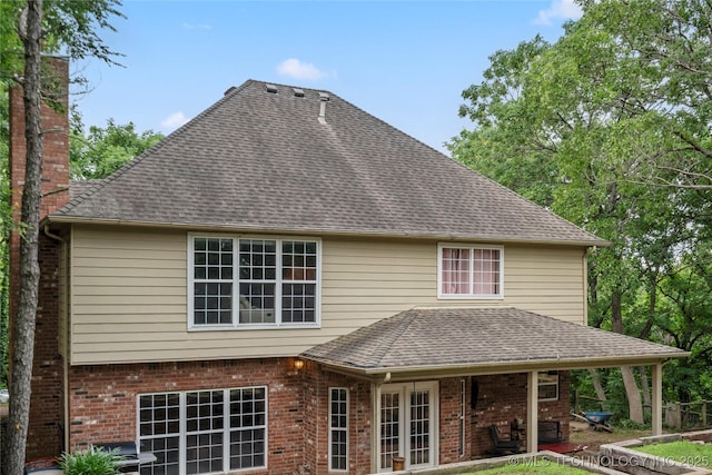 11937 S 18th St, Jenks, OK 74037 - back of house featuring a chimney, a shingled roof, and brick siding