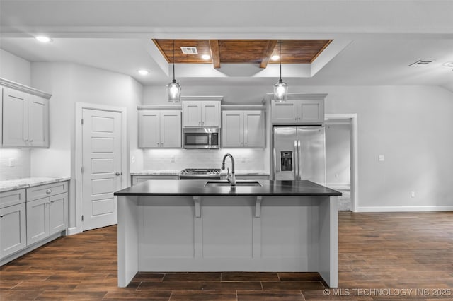 21893 S Arlene Dr, Claremore, OK 74019 - kitchen featuring stainless steel appliances, a sink, a raised ceiling, dark wood finished floors, and tasteful backsplash