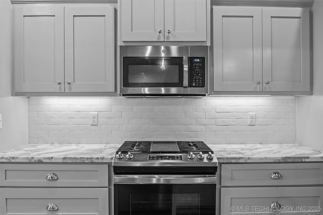 21893 S Arlene Dr, Claremore, OK 74019 - kitchen with appliances with stainless steel finishes, backsplash, and light stone countertops