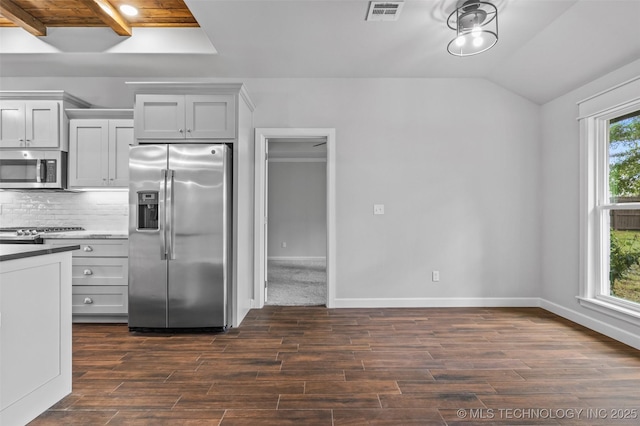 21893 S Arlene Dr, Claremore, OK 74019 - kitchen featuring stainless steel appliances, dark wood-type flooring, decorative backsplash, baseboards, and vaulted ceiling