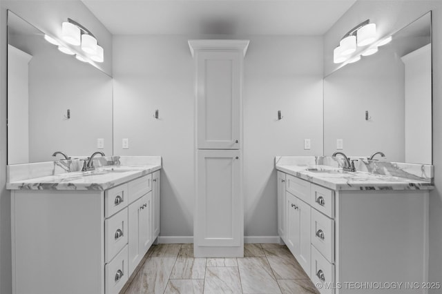 21893 S Arlene Dr, Claremore, OK 74019 - bathroom featuring two vanities, marble look tile flooring, and baseboards
