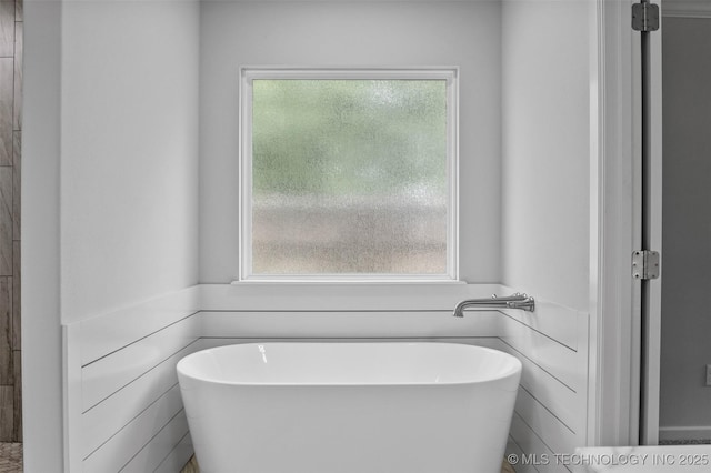 21893 S Arlene Dr, Claremore, OK 74019 - bathroom featuring a freestanding bath and plenty of natural light