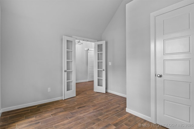 21893 S Arlene Dr, Claremore, OK 74019 - unfurnished bedroom featuring french doors, baseboards, dark wood finished floors, lofted ceiling, and a chandelier