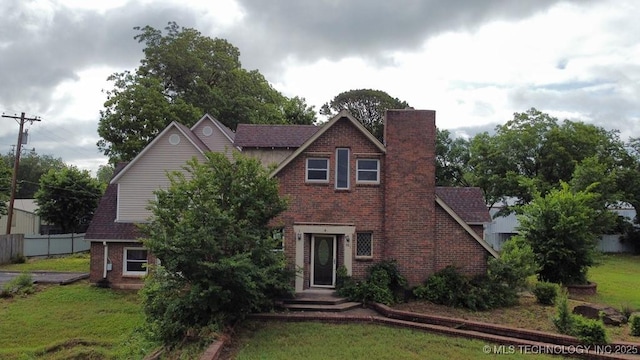 903 S Lynn Ln, Tulsa, OK 74108 - tudor house featuring brick siding and a chimney