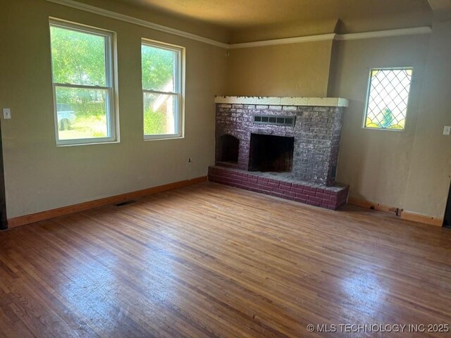 903 S Lynn Ln, Tulsa, OK 74108 - unfurnished living room with wood finished floors, ornamental molding, baseboards, and a fireplace
