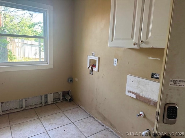 903 S Lynn Ln, Tulsa, OK 74108 - washroom with light tile patterned floors, hookup for a washing machine, cabinet space, and plenty of natural light